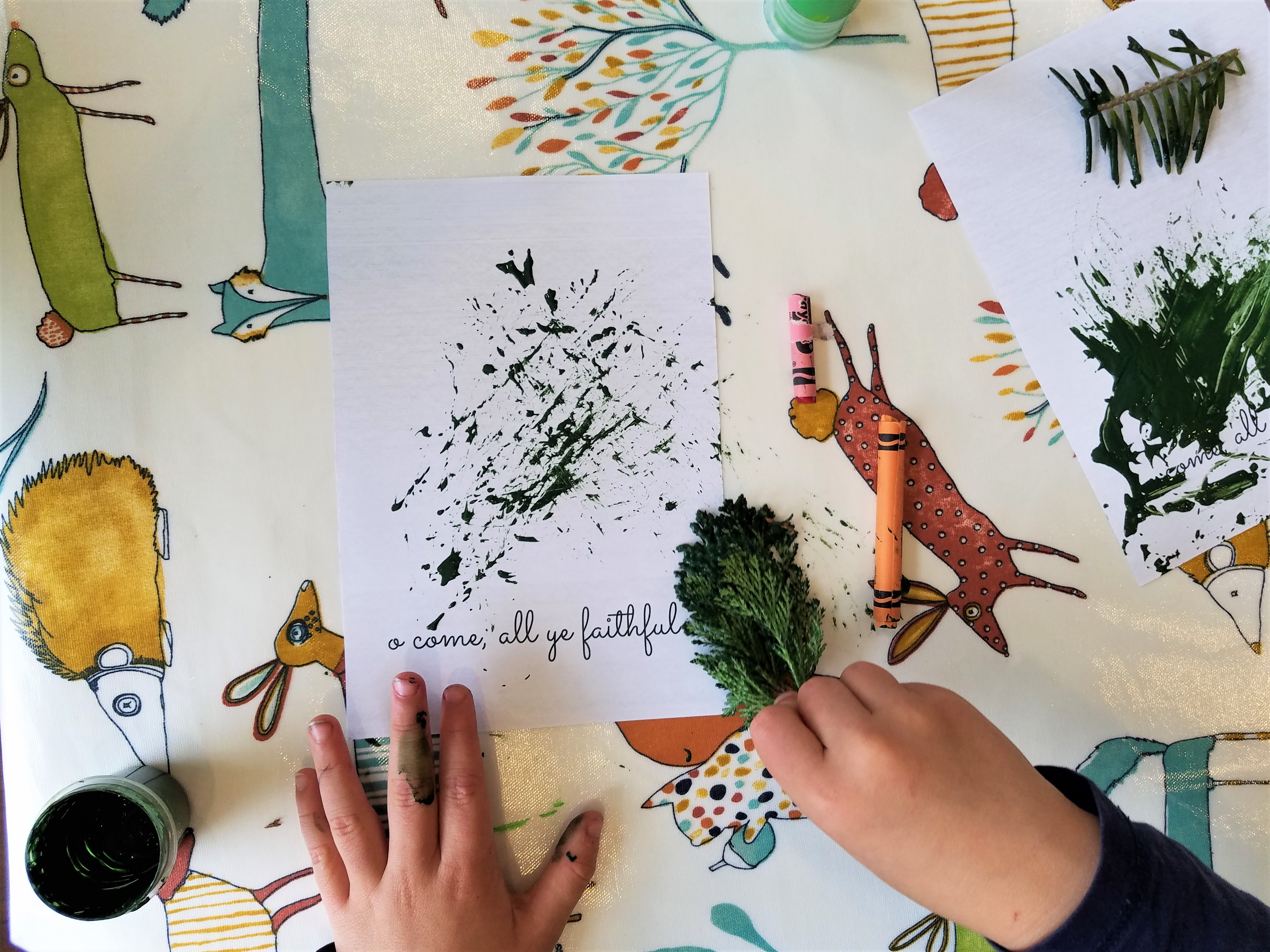 child using nature items to make Christmas cards